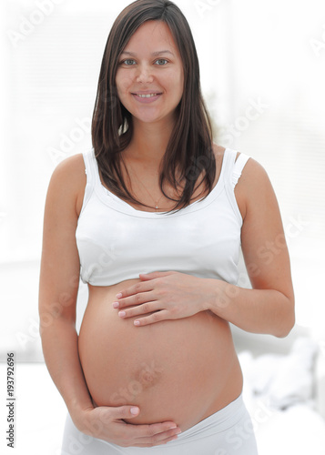 portrait of young pregnant woman on a light background. Free Download portrait of young pregnant woman on a light background. - GFXLoad