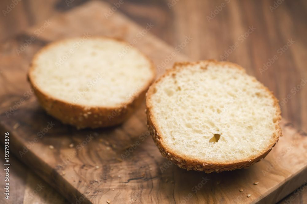 sliced sesame bun on wood board sliced sesame bun on wood board
