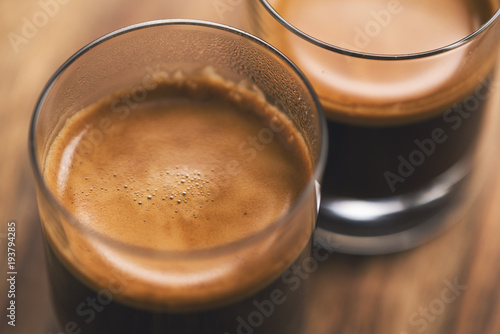 two shots of espresso on wood table photo