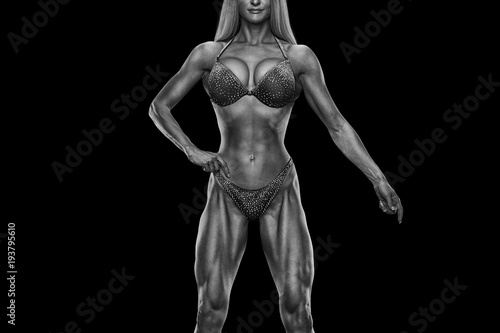 Cropped black white photo Fitness bikini model well trained body Sports competition female champion stage Athlete bodybuilder posing Perfect strong body trained shape arms abs chest legs Clipping path © USM Photography