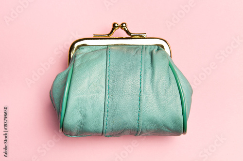 Purse for coins.Wallet for change. Leather purse, purse on a pink background. Color of the trend.The concept of poverty photo