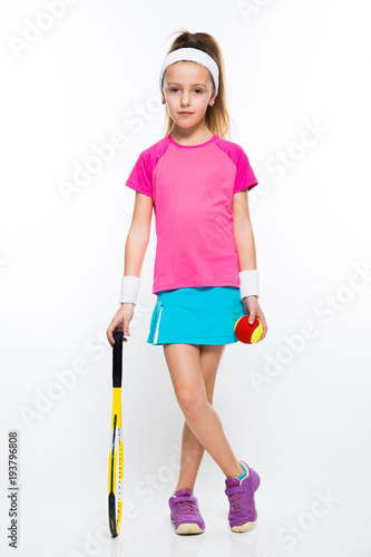 Cute little girl with tennis racket and ball on white background