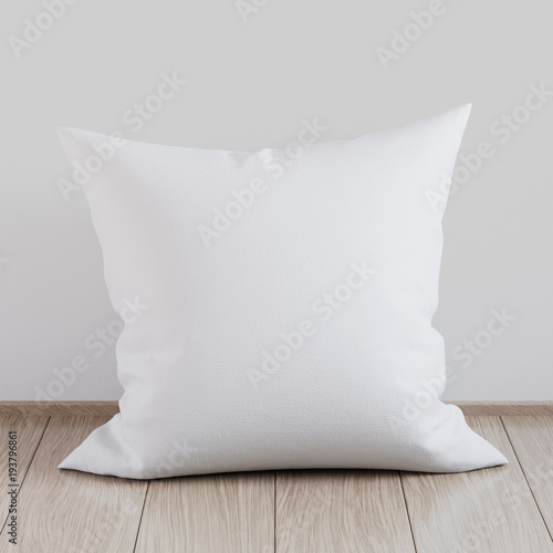 Blank white soft square pillow on a wooden floor near the wall, 3D render