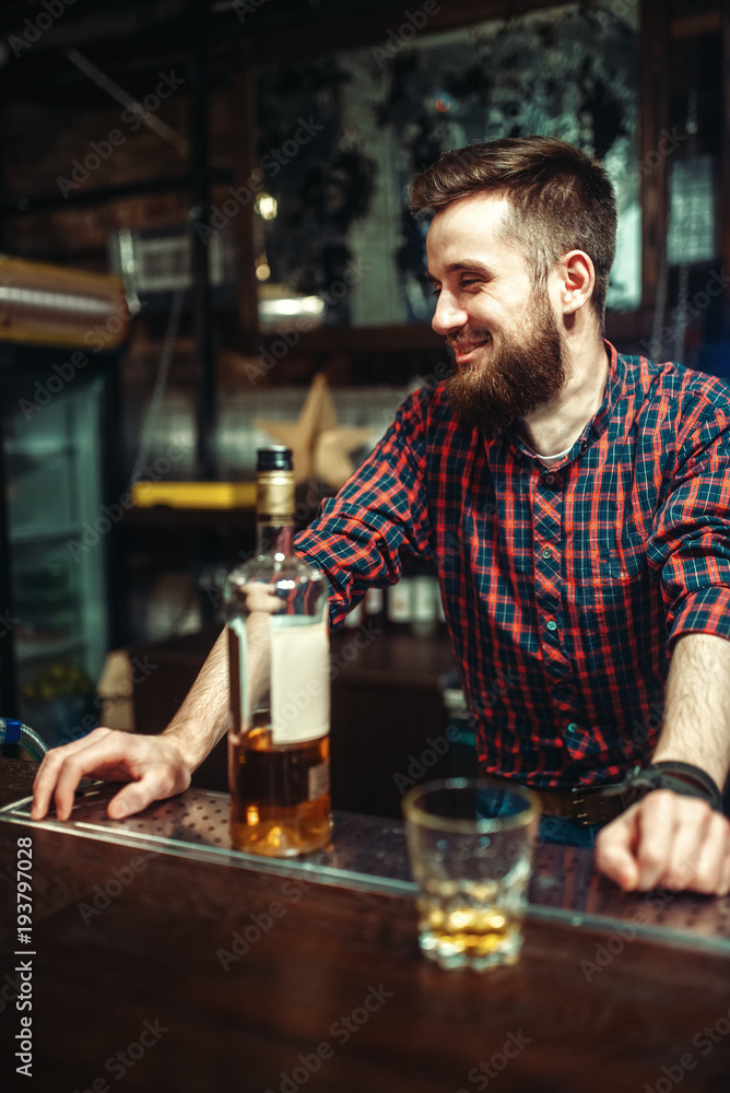 One man standing at the bar counter, drunkenness