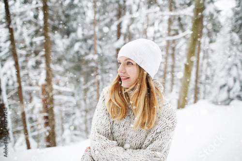 Beautiful winter portrait of young woman in the winter snowy scenery. Happy winter moments. Christmas Girl