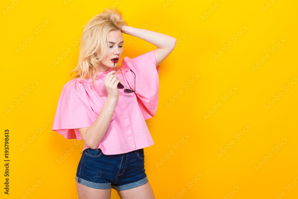 Blonde woman in pink blouse with sunglasses Blonde woman in pink blouse with sunglasses