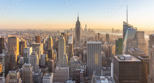 New York City. Manhattan downtown skyline with illuminated Empire State Building and skyscrapers at sunset. USA.