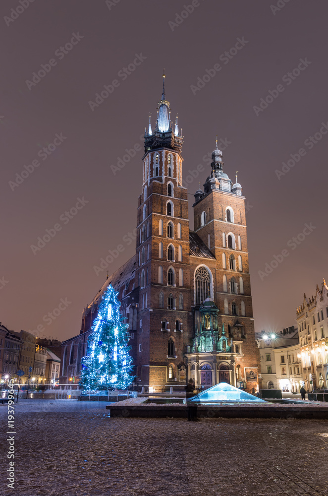 Krakow, Poland, Christmas tree and St Mary's church on Main Market square