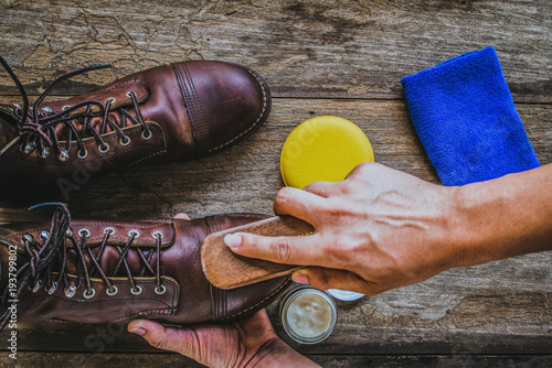 Man polishing leather shoes with brush