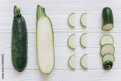 Zucchini is shredded on the white wooden background, top view. photo