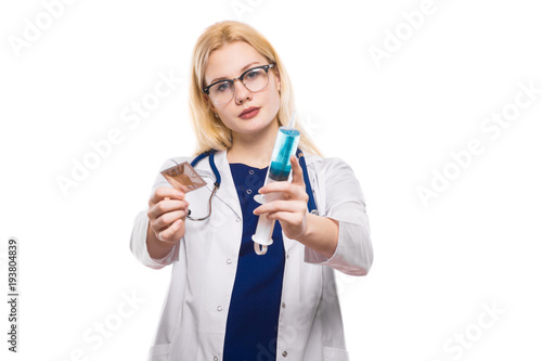 Woman doctor hold condom and injection photo