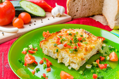 Cauliflower with cheese and vegetables baked in the oven
