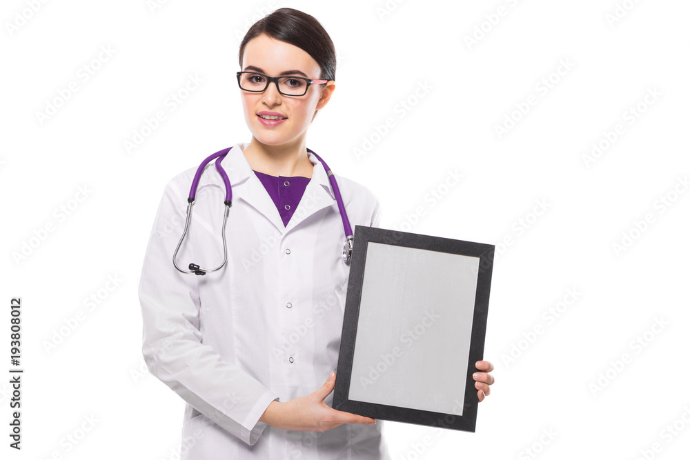 Successful young woman doctor with stethoscope showing frame in her hands in white uniform on white background Successful young woman doctor with stethoscope showing frame in her hands in white uniform on white background