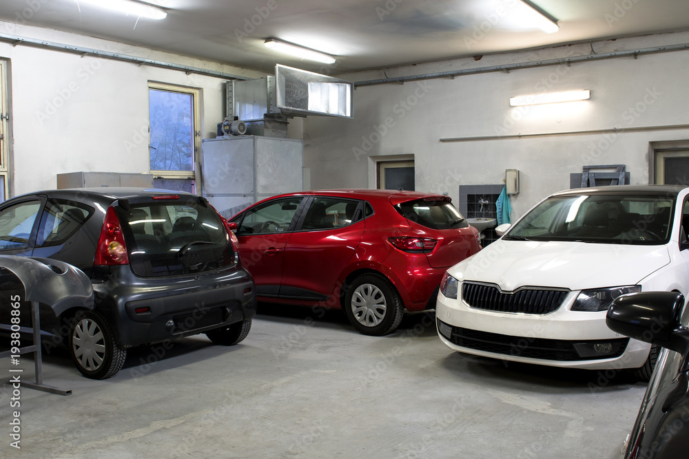 Cars in a workshop waiting to be repaired. Cars in a workshop waiting to be repaired.