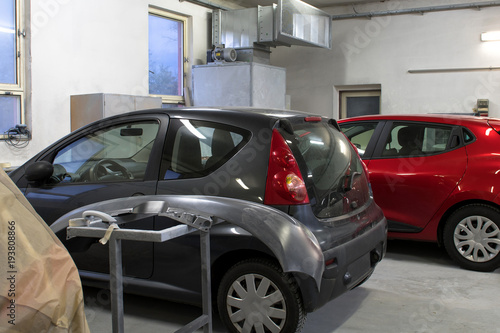 Cars in a workshop waiting to be repaired.