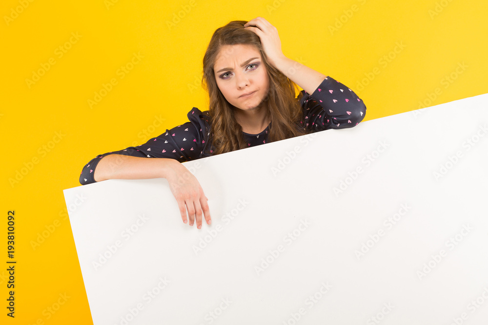 Attractive upset woman with blank banner Attractive upset woman with blank banner