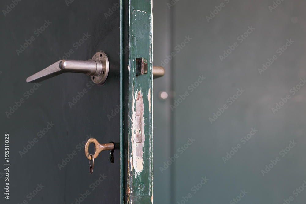 Green wooden door and door klink close-up Green wooden door and door klink close-up