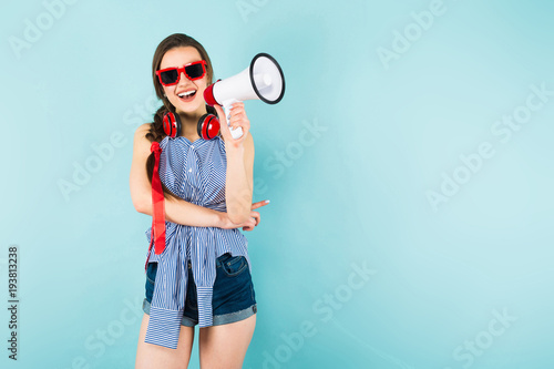 Young sexy woman with headphones and loudspeaker © Ivan Traimak