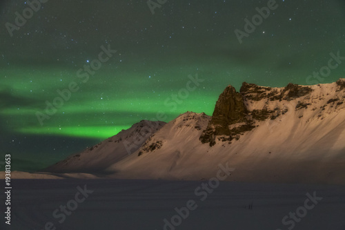 Aurora borealis over the mountains is Iceland