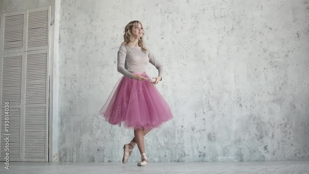 ballet dancer in a pink tutu and pointe shoes. beautiful young ballerina at a rehearsal. lightness and grace of the ballet. slow motion ballet dancer in a pink tutu and pointe shoes. beautiful young ballerina at a rehearsal. lightness and grace of the ballet. slow motion