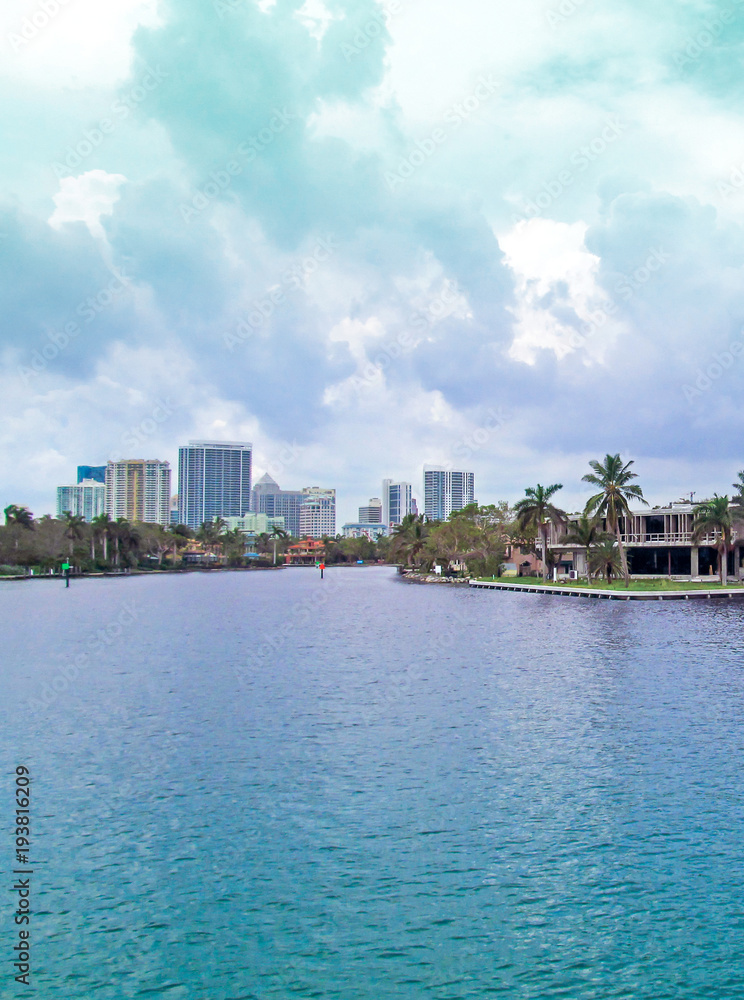 Canal of Fort Lauderdale, Florida, USA.
Panoramic view of downtown with luxurious estates, palm trees on the waterfront and boats on cloudy day. Canal of Fort Lauderdale, Florida, USA.
Panoramic view of downtown with luxurious estates, palm trees on the waterfront and boats on cloudy day.