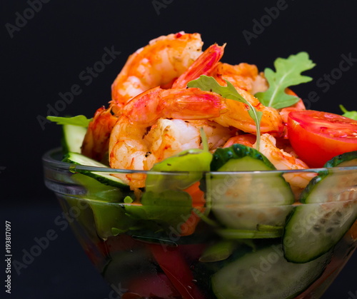 Food. Langoustines salad, black background