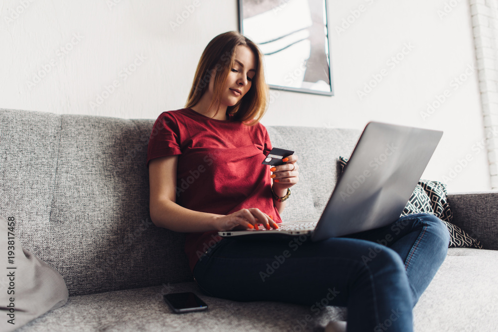 Woman doing online shopping with laptop and credit card at home Woman doing online shopping with laptop and credit card at home