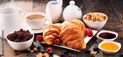 Breakfast served with coffee, croissants, cereals and fruits © monticellllo