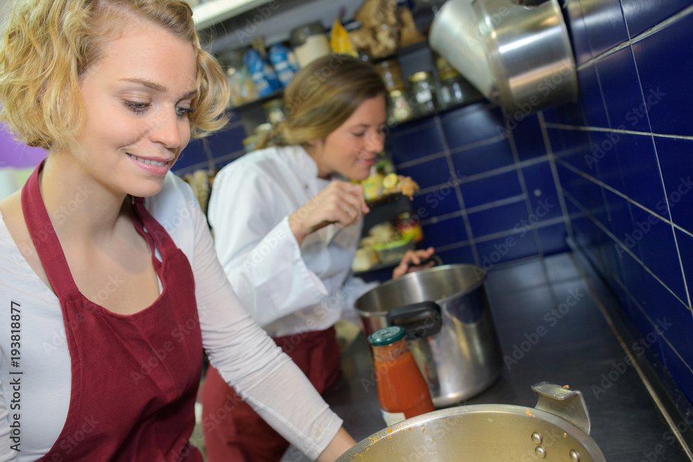 young woman chef cooking in kitchen young woman chef cooking in kitchen
