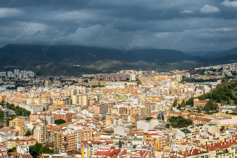 Cityscape aerial view of Malaga before the rain, Andalusia, Spain