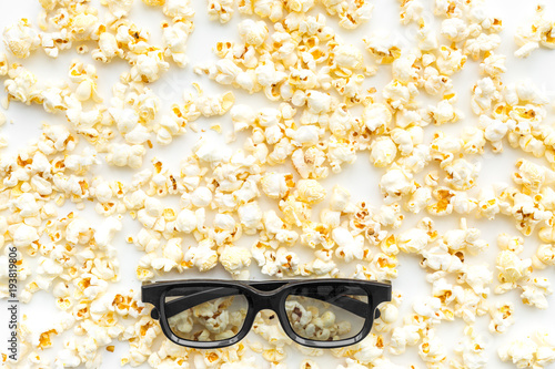 Cinema accessories. Cinema glasses and popcorn on white background top view copy space