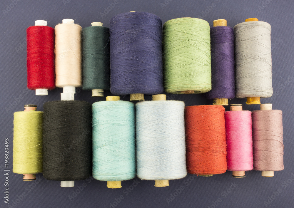 multi-colored skeins of threads on a blue background multi-colored skeins of threads on a blue background