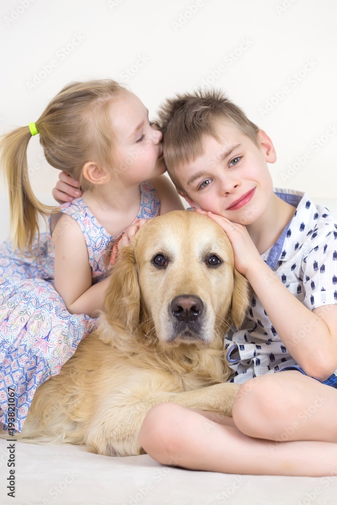 Cute Happy Kids Playing With Golden Retriever Dog On Bed Cute Happy Kids Playing With Golden Retriever Dog On Bed