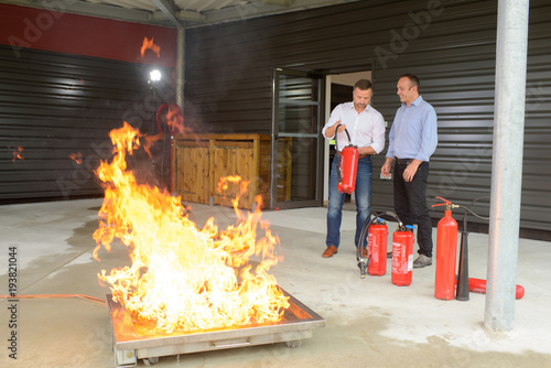 Firemen performing controlled fire training photo