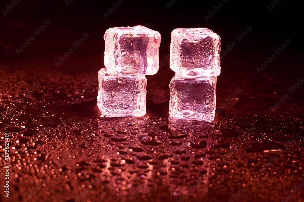 Red ice cubes on black background. Red ice cubes on black background.