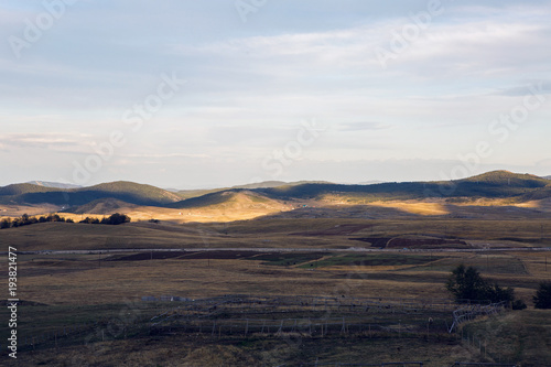 sunrise in Montenegro mountains in the background and fields in the Park zabljak