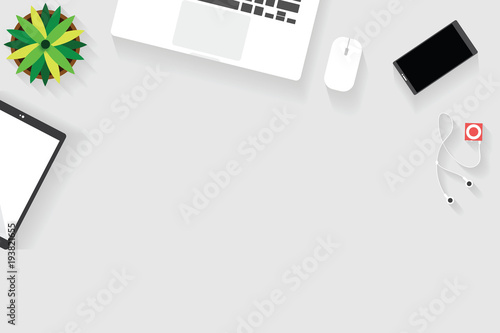 Top view of table working and working desk with gadget and free space for text with accessory on the table, desk top, keyboard, book, pen, flowerpot and coffee cup