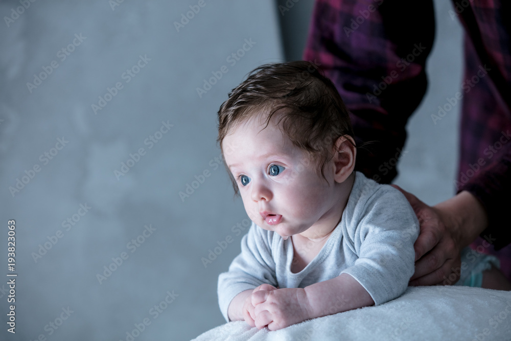 Fototapeta premium Little child lying down in fitball