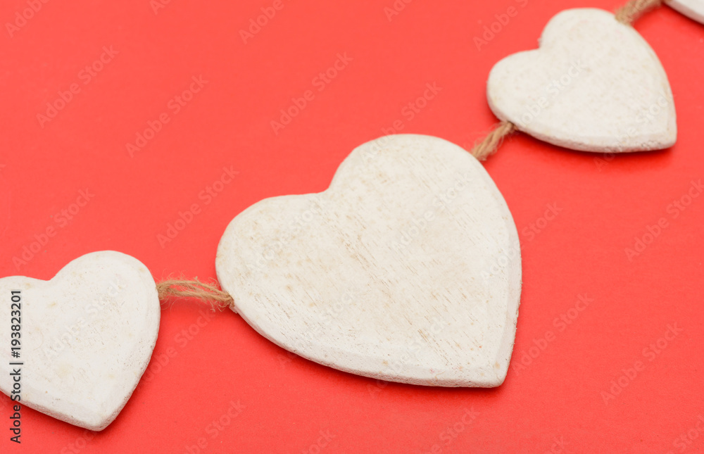 Obraz premium Closeup of Heart wooden shape on red background