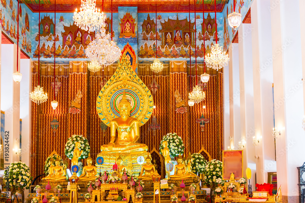 beautiful altar of a Buddhist temple with sculptures of the god Buddha