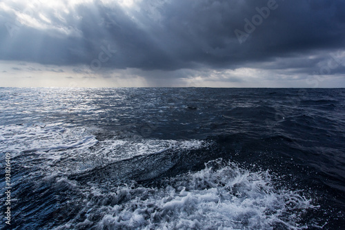 Big storm in ocean with blue clouds and water
