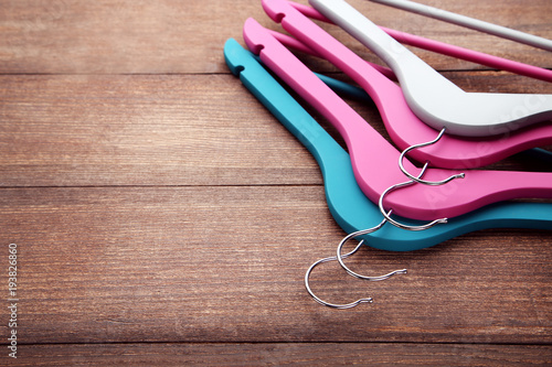 Colorful hangers on brown wooden table