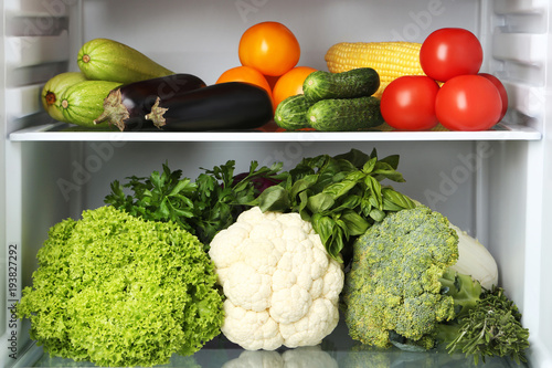 Open fridge full of vegetables