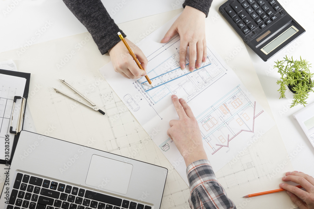 Architects working on blueprint, real estate project. Architect ...