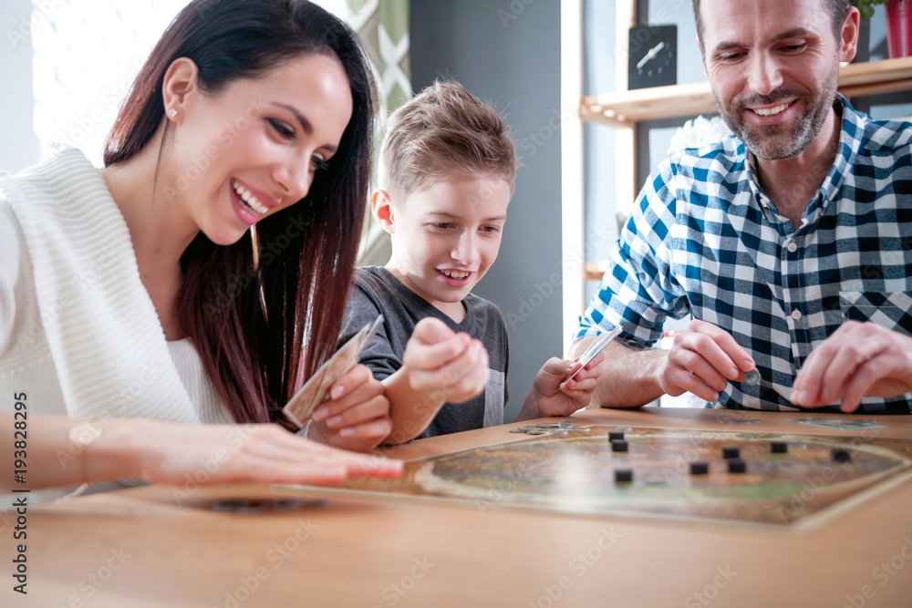 Happy family playing board game at home Happy family playing board game at home