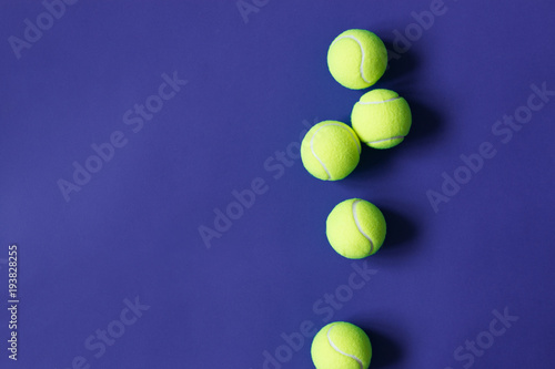 Yellow tennis balls on violet background. Concept sport. © Olha Kozachenko