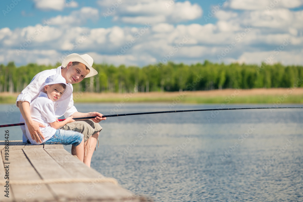 a boy with his father on the weekend on a fishing trip together spend time a boy with his father on the weekend on a fishing trip together spend time