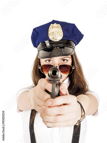 Beautiful young girl with a gun, isolated on white background. A teenage girl is holding a gun in her hands.