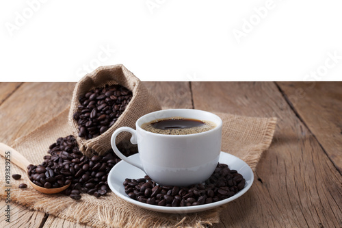 coffee cup and coffee beans on old wood plank background.