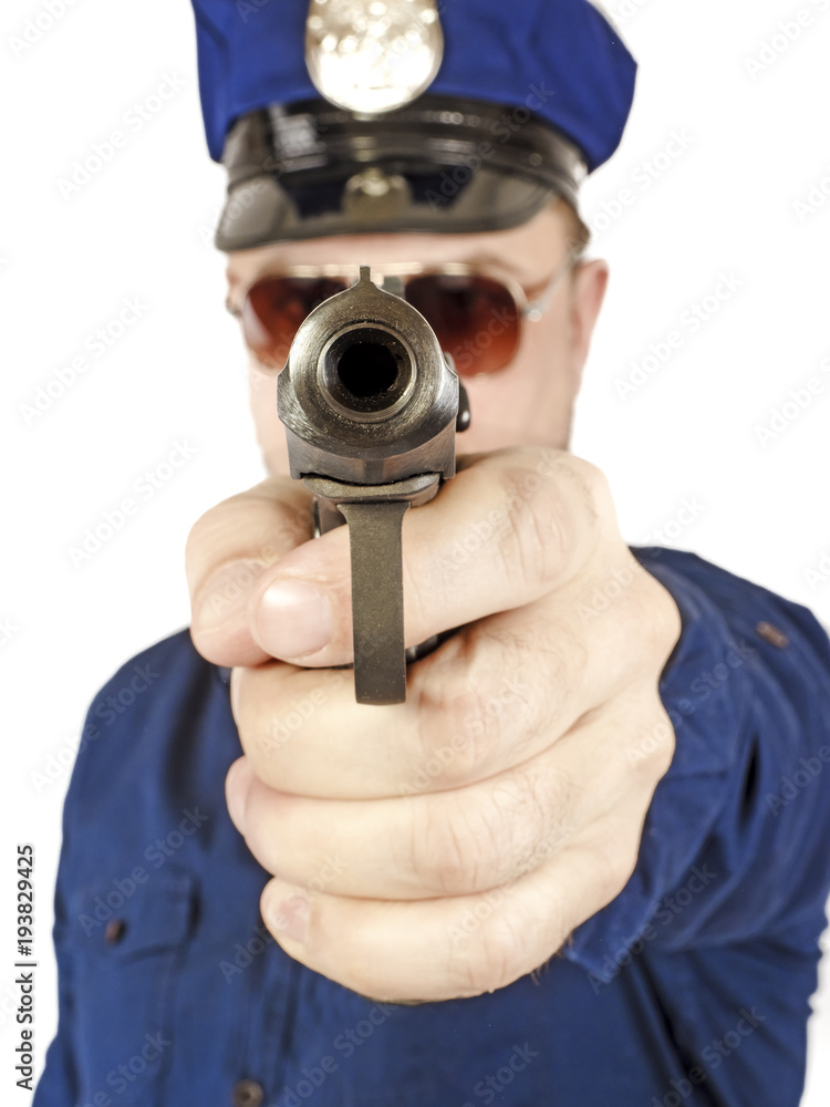 Duty policeman aiming the gun at the camera Duty policeman aiming the gun at the camera